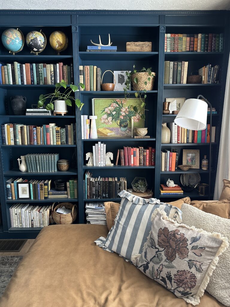 living library bookcases filled with books and antiques